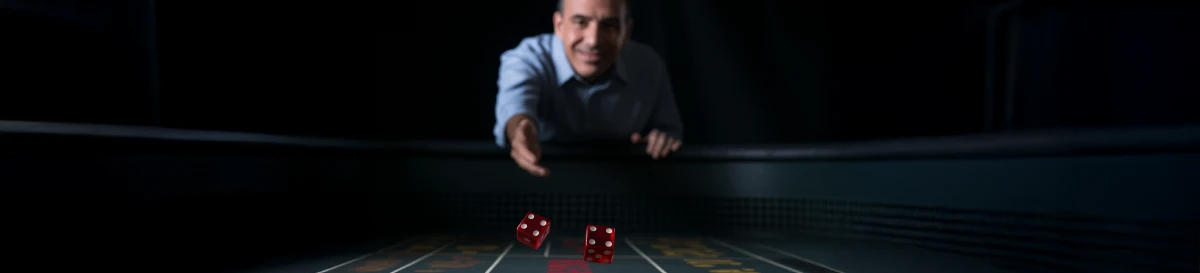Craps player mid-throw at a casino table, demonstrating a controlled dice toss in action